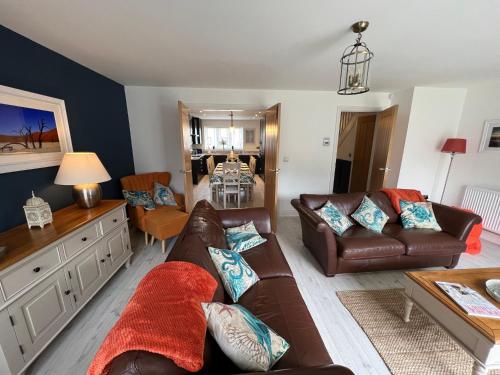 a living room with a couch and a table at CAPTAINS HOUSE WHITBY - HOT TUB - Luxury in Whitby