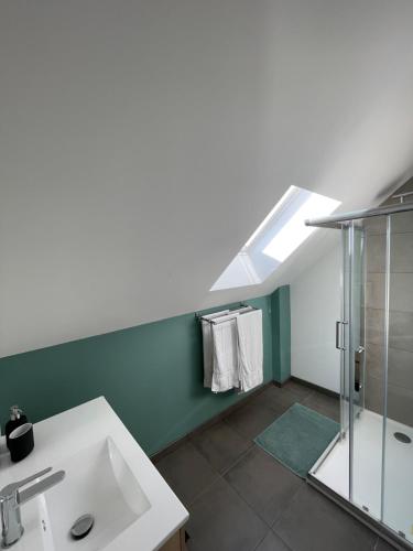 a bathroom with a sink and a shower at Maison rénové bourg de Plourhan in Plourhan