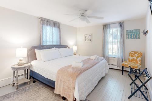 a bedroom with a large bed with a ceiling fan at Town of Rehoboth Beach 45 Baltimore Ave in Rehoboth Beach