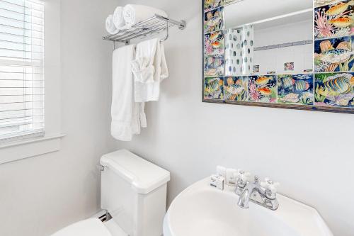 a white bathroom with a toilet and a mirror at Town of Rehoboth Beach 45 Baltimore Ave in Rehoboth Beach
