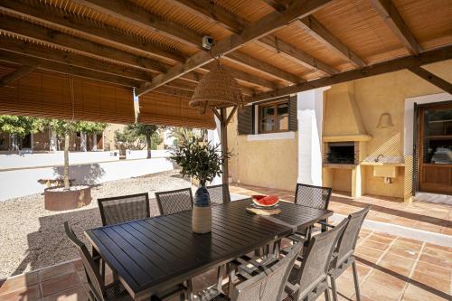 a black table and chairs on a patio at CAN NOVES - Villas de 4 suites 52 y 35 in Sant Francesc Xavier