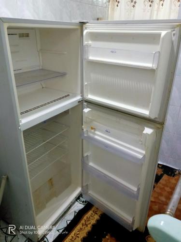 an empty refrigerator with its door open in a kitchen at شقة مفروشة للايجار بدمياط القديمة in Dumyāţ