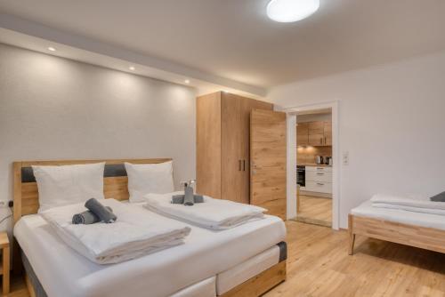 a bedroom with two beds with white sheets at Natur Residenz Bad Häring in Bad Häring