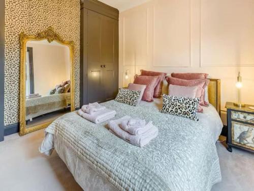 a bedroom with a large bed with towels on it at Dreamy home in the heart of Whitstable in Kent