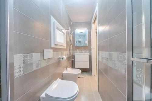a bathroom with a toilet and a sink at Arabesque Luxury Apartment - Roof Garden in Taranto