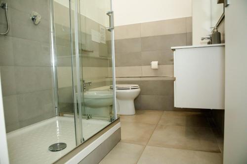 a bathroom with a toilet and a glass shower at La Bella Salernitana in Salerno