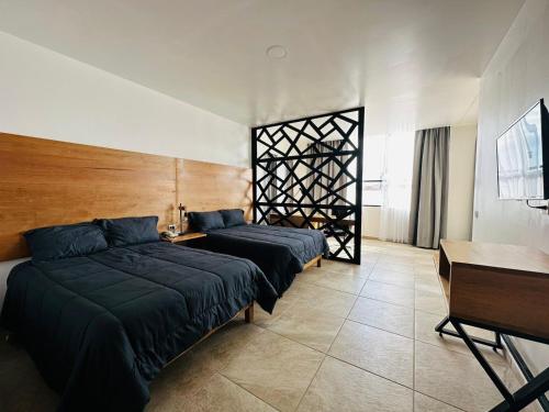 Postel nebo postele na pokoji v ubytování Hotel La Mansión
