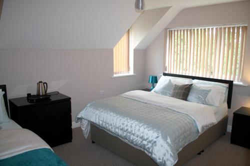 a bedroom with a bed with white sheets and a window at B&B Dorwyn Manor in Avebury