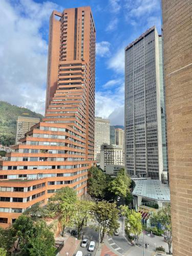 a tall building in a city with many buildings at Mitika Cultura movilidad y tranquilidad in Bogotá