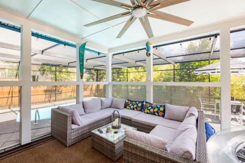 a screened in porch with a couch and a table at Beautiful Clearwater home! in Clearwater