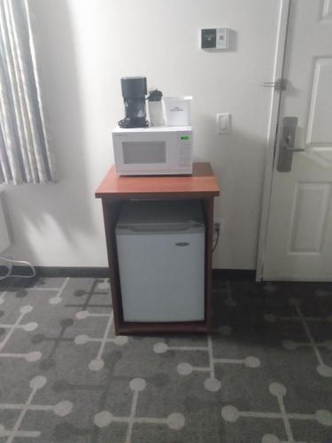 a microwave sitting on top of a table in a room at Howard Johnson by Wyndham Roseburg in Roseburg