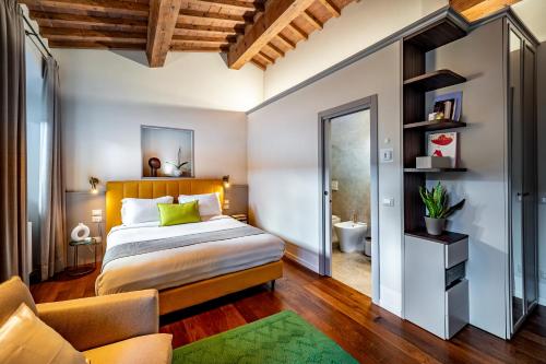 a bedroom with a bed and a bathroom at Dimora Collection - Le Torri - Boutique Luxury Suites - Adults Only in Florence