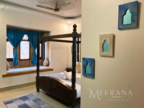 a bedroom with a bed and a window at Hotel Meerana in Jaisalmer