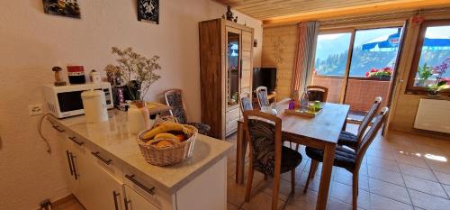 a kitchen and dining room with a table and a dining room at Bleuet K5 in Champoussin