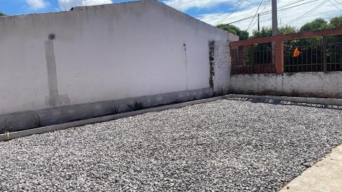 an empty parking lot next to a white wall at Hotel Ikawa in La Loma