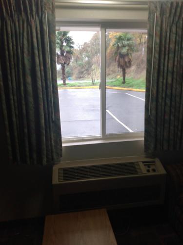 a window with a view of a parking lot at Howard Johnson by Wyndham Roseburg in Roseburg