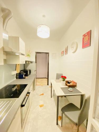 a kitchen with a table and a dining room at Milano Relax Room in Brugherio