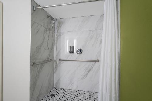 a bathroom with a shower with a shower curtain at Sleep Inn in Madison