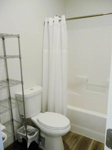 a white bathroom with a toilet and a shower at Bunkhouse 1B Sleeps 4 in La Verkin