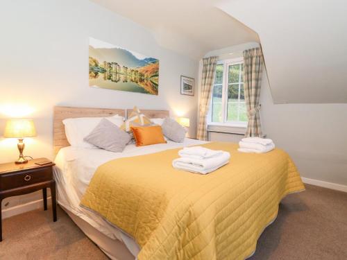 a bedroom with two beds with towels on them at Grey Walls in Penrith