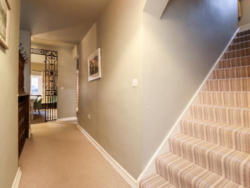 a hallway with stairs in a home at Grey Walls in Penrith