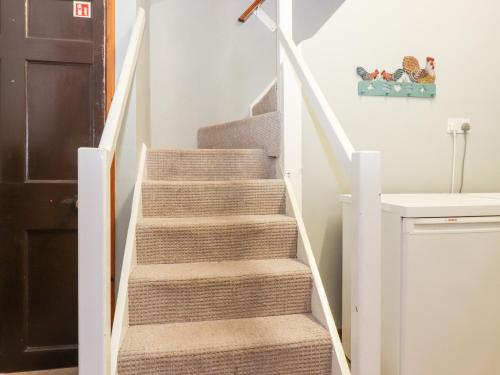 a staircase in a house with a stair case at Grey Walls in Penrith