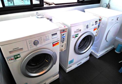 two washing machines and a washer and dryer in a room at Non@Chiang Mai in Chiang Mai