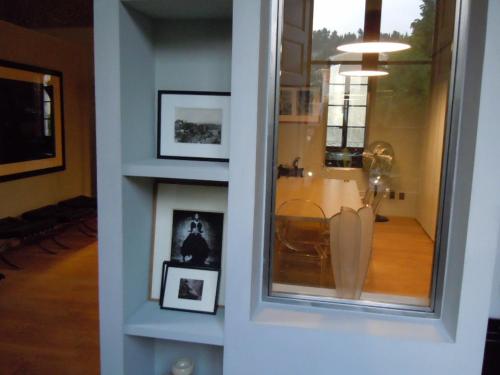 a room with a window and a table with pictures at Luxury two bedroom apartment in Apt, the heart of the Luberon in Apt