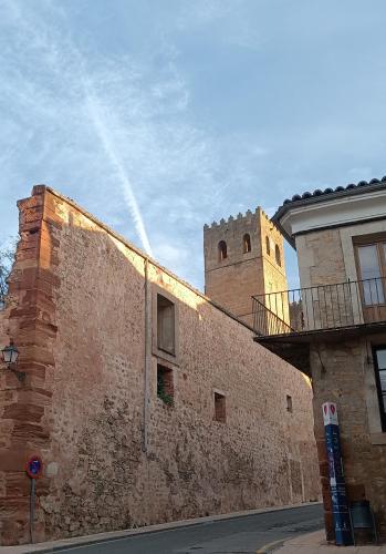 a building with a clock tower on top of it at VUT Casa de la Catedral Baja in Sigüenza