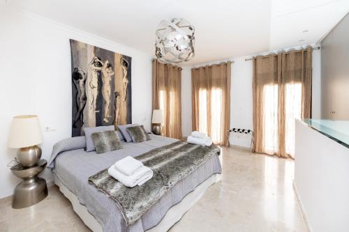 a bedroom with a large bed with towels on it at CASA SAN MATIAS in Granada