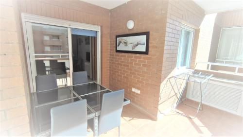 a room with two chairs and a brick wall at Apartamentos varios con 2 dorm en Marina Dor , la playa de Amplaries 47 , vista lateral al mar in Oropesa del Mar