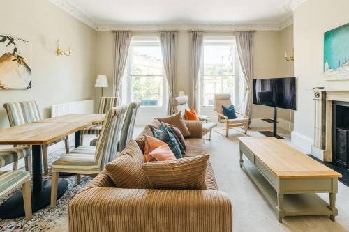 a living room with a couch and a table at Luxury, Central, Sun-Filled 3 Bed Haven in Bath in Bath