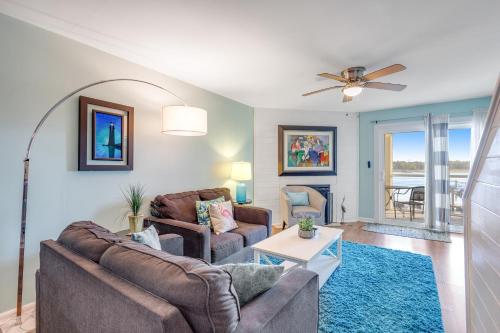 a living room with two couches and a table at Mariners Cay 68 in Folly Beach