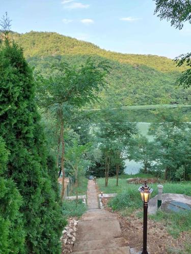 a street light in the middle of a path with a mountain at "Kod dva kestena"Warm and cozy house with lake view sauna in Međuvršje