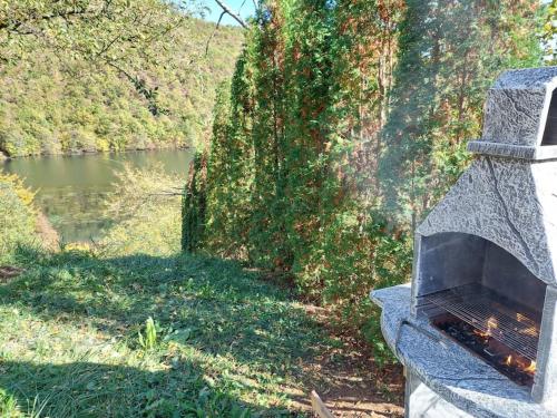 a stone oven sitting next to a river at "Kod dva kestena"Warm and cozy house with lake view sauna in Međuvršje