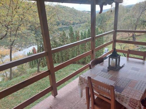 a room with a table and a view of a river at "Kod dva kestena"Warm and cozy house with lake view sauna in Međuvršje