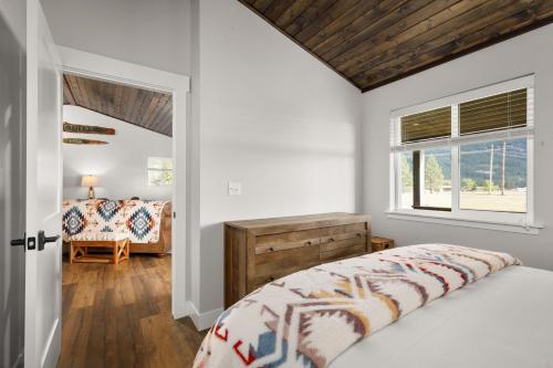 a bedroom with a bed and a window at The Kabins in Columbia Falls