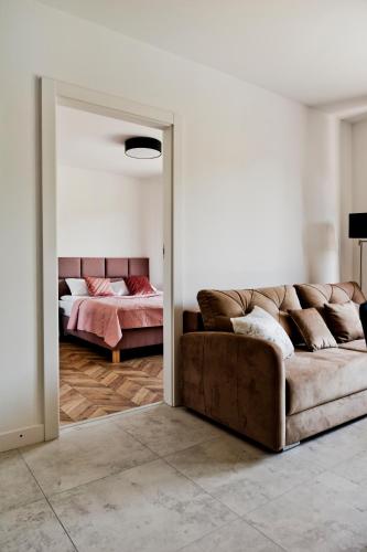a living room with a couch and a bed at Apartamenty Belni Hel Edyta i Maciej Wolak in Hel