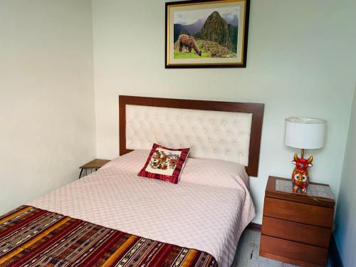 a bedroom with a bed with a pillow on it at Peruvian House - Miraflores in Lima