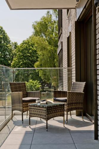 a group of chairs and a table on a balcony at Apartamenty Belni Hel Edyta i Maciej Wolak in Hel
