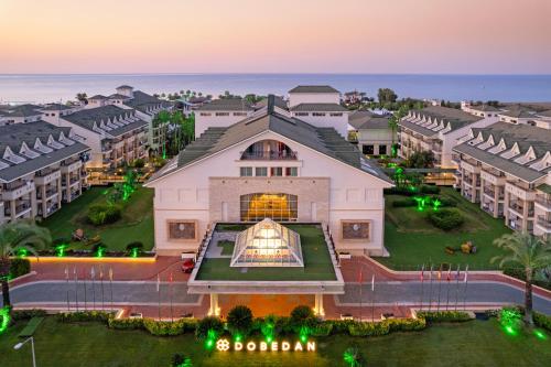 an aerial view of a building at dusk at Dobedan Exclusive Hotel & Spa ''Ex Brand Alva Donna Exclusive Hotel & Spa'' in Belek