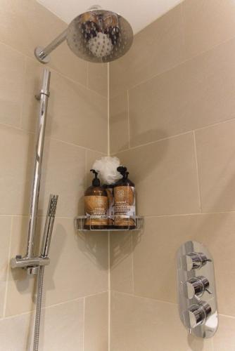 a bathroom with a shower with two shelves on the wall at The Barbican in York