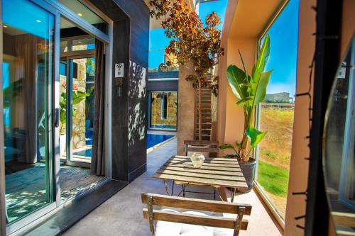 a room with a table and bench on a porch at Hill Valley Asilah - Luxury Living & Boutique Hotel in Asilah
