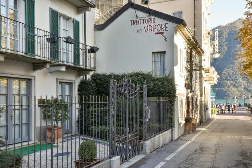 a building with a gate in front of a street at Cernobbio lake suites in Cernobbio