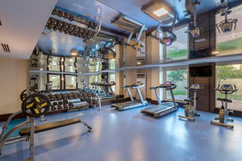 a gym with several treadmills and cardio machines at Dobedan Exclusive Hotel & Spa ''Ex Brand Alva Donna Exclusive Hotel & Spa'' in Belek