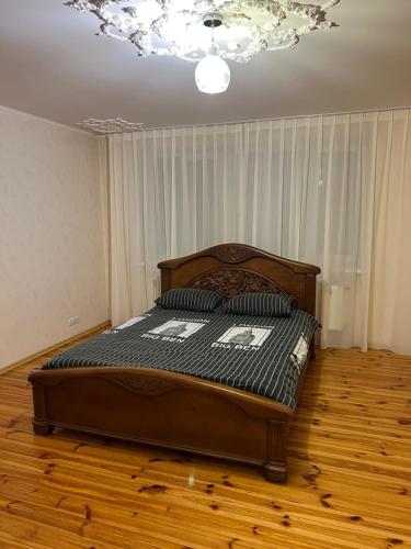 a bedroom with a large bed with two pillows on it at Апартаменты с двумя спальнями в центре города! in Cherkasy