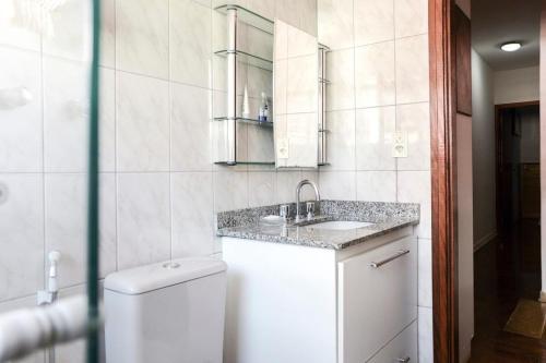 a bathroom with a sink and a toilet at Casa Compartilhada na Aclimação by BnbHost in Sao Paulo