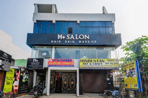a store with signs in front of a building at SPOT ON Hotel Utrishree in Bhubaneshwar