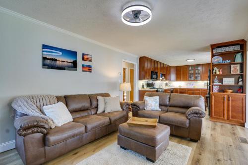 a living room with a brown couch and a chair at Lakefront Getaway in Leesburg with Dock and Kayaks! in Leesburg