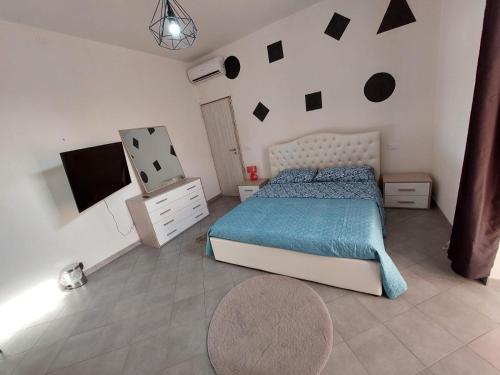 a bedroom with a bed and a wall with black squares at Borgo’s app in Bologna